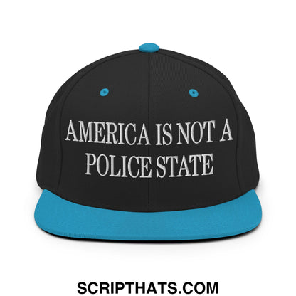 Black snapback cap with teal brim and button featuring white embroidered text america is not a police state