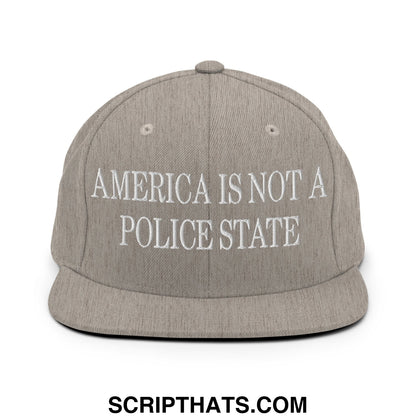 Gray snapback hat with white embroidered text america is not a police state and flat bill brim design