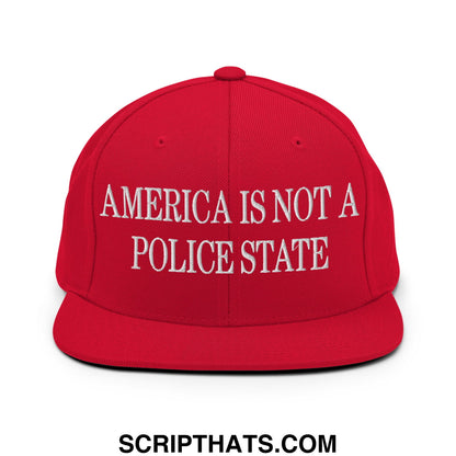 Red snapback cap with white embroidered text america is not a police state and a flat bill brim design