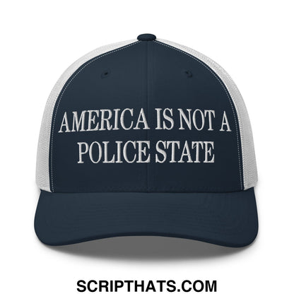 Dark blue and white mesh trucker hat with embroidered america is not a police state text in classic serif font