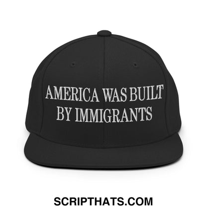 Black snapback hat with white embroidered america was built by immigrants text and flat bill brim design
