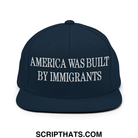 Navy blue snapback hat with white embroidered america was built by immigrants text and flat bill brim design