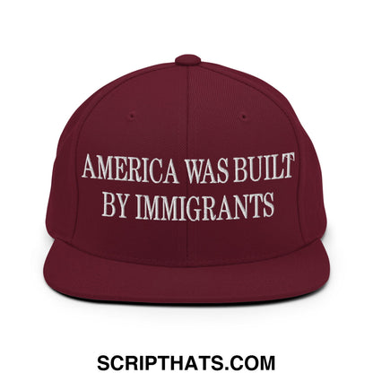 Maroon embroidered flat bill brim snapback hat with white text america was built by immigrants