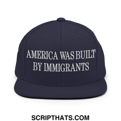 Navy blue snapback hat with white embroidered america was built by immigrants text flat bill brim design