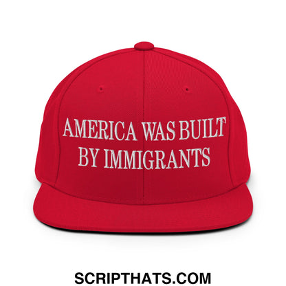 Red flat bill snapback hat with white embroidered america was built by immigrants text on front panel