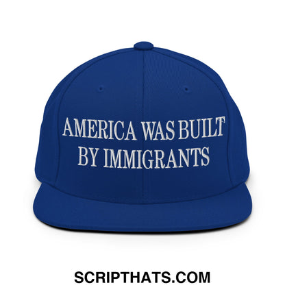 Royal blue snapback hat with white embroidered america was built by immigrants text and flat bill brim design