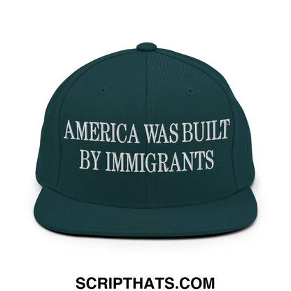 Dark green snapback hat with white embroidered text america was built by immigrants flat bill brim design