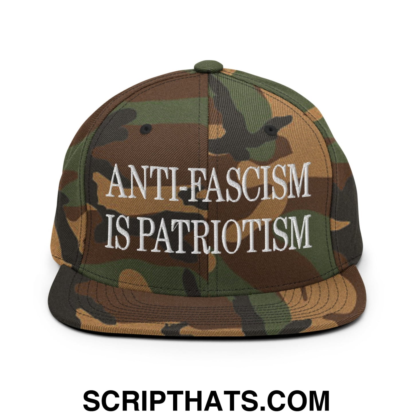 A camouflage snapback hat with white embroidered text anti fascism is patriotism and a flat bill brim