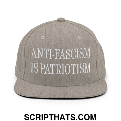 Gray snapback hat with white embroidered anti-fascism is patriotism text and flat bill brim for casual wear