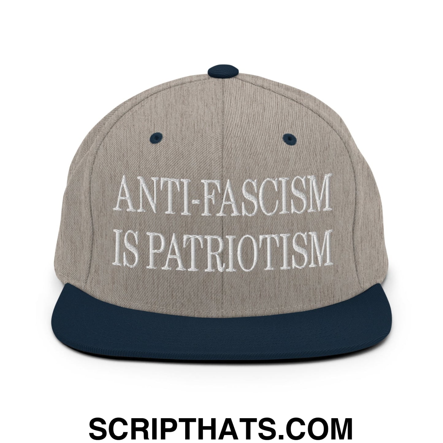 A gray and navy blue snapback hat with white embroidered text anti-fascism is patriotism and flat bill brim