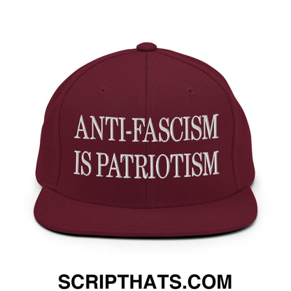 Maroon flat bill snapback hat with white embroidered text anti-fascism is patriotism for casual wear