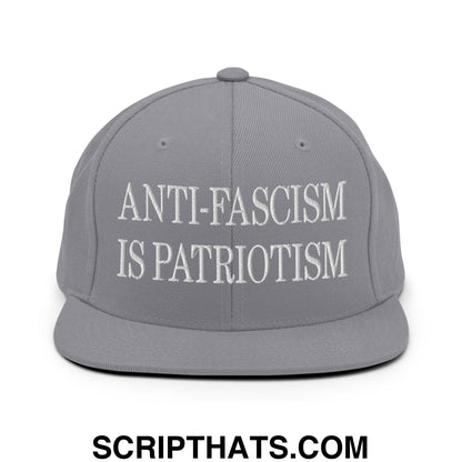 Gray snapback hat with white embroidered anti-fascism is patriotism text and flat bill brim design