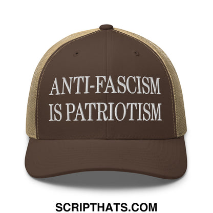 Brown and tan mesh trucker hat with white embroidered text anti fascism is patriotism on front panel