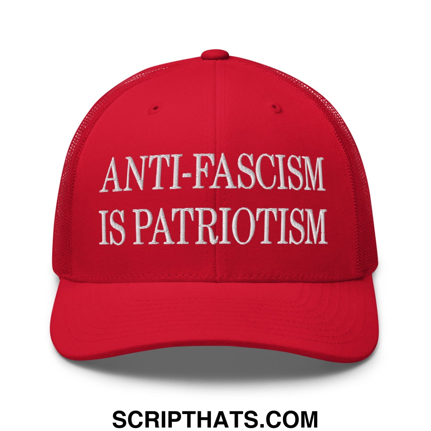 Red mesh trucker hat with white embroidered text anti fascism is patriotism on the front panel