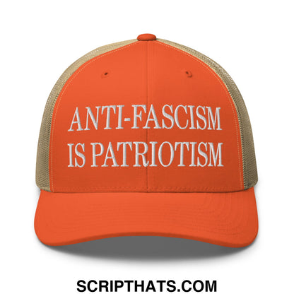 Orange and beige mesh trucker hat with white embroidered anti-fascism is patriotism text design