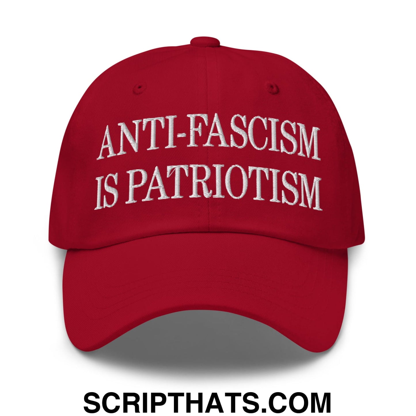 Red unstructured dad hat with white embroidered text anti-fascism is patriotism made of cotton blend