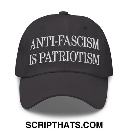 Black unstructured dad hat with white embroidered anti-fascism is patriotism text in a casual style