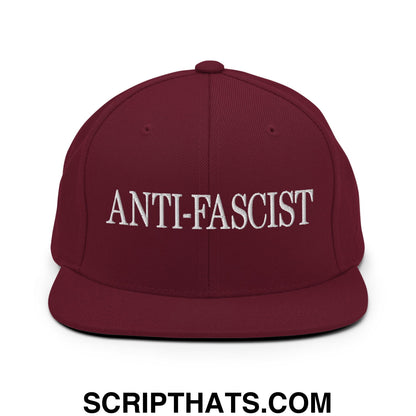 Maroon snapback hat with white embroidered anti-fascist text and flat bill brim for casual wear