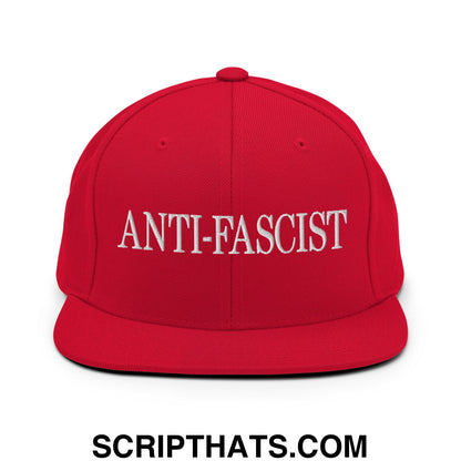 Red snapback cap with white embroidered anti fascist text on front flat bill brim for casual wear