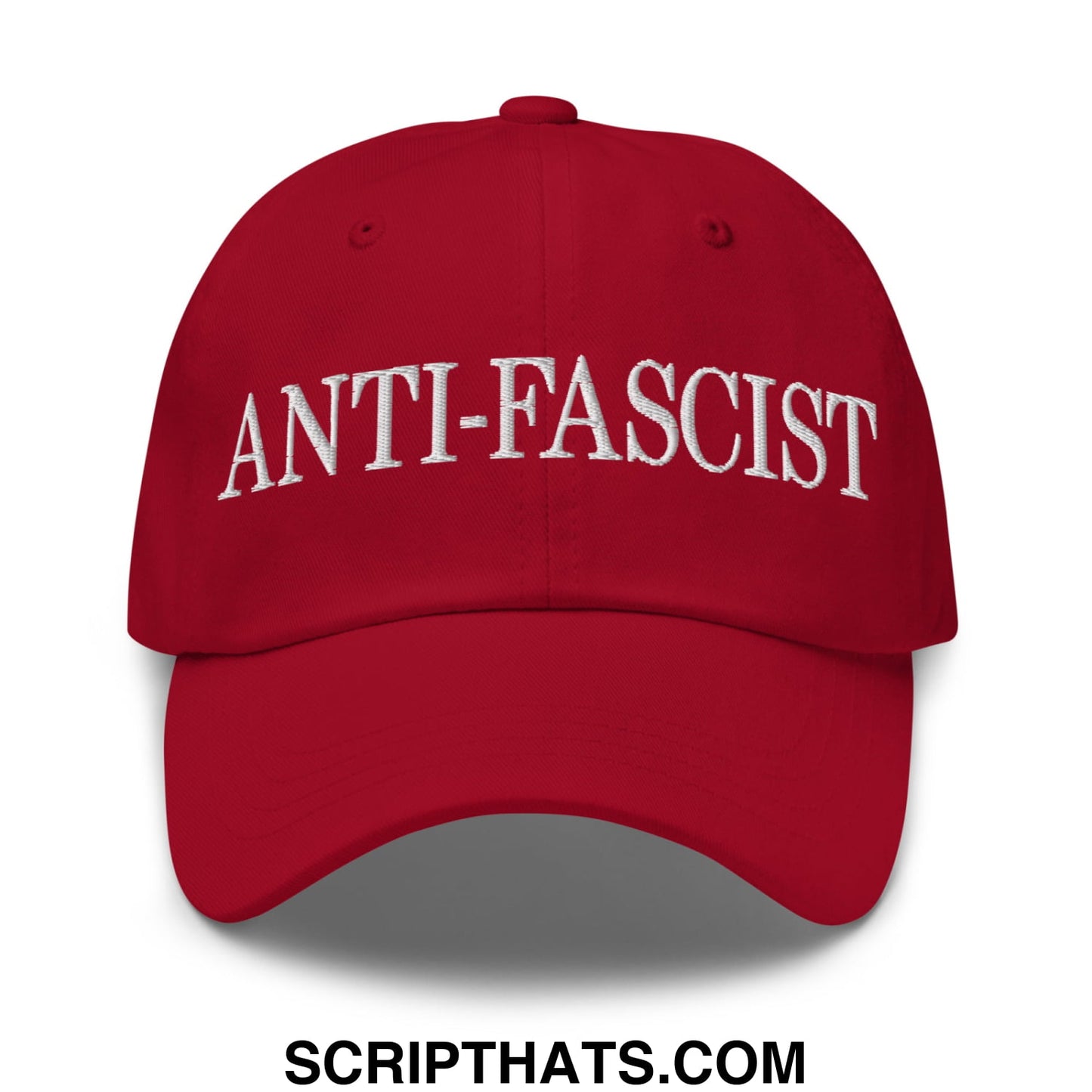 Red unstructured dad hat with white embroidered anti-fascist text on front for casual wear