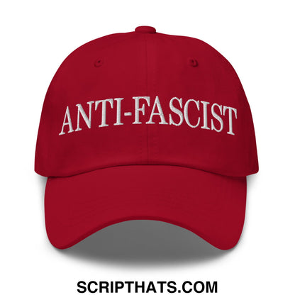 Red unstructured dad hat with white embroidered anti-fascist text on front for casual wear