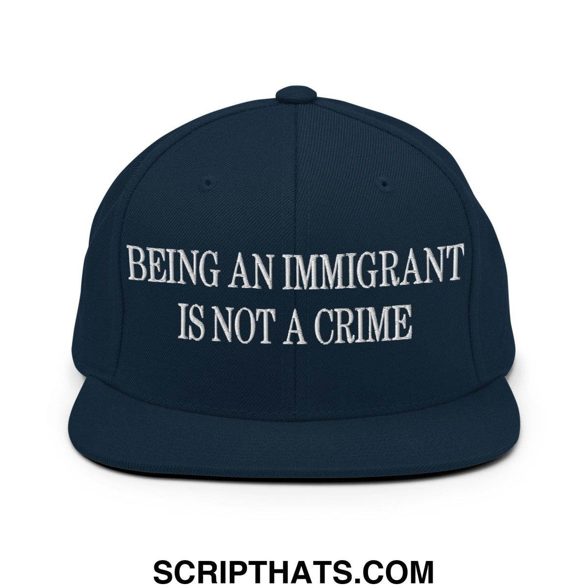 Navy blue snapback hat with white embroidered text being an immigrant is not a crime flat bill brim design
