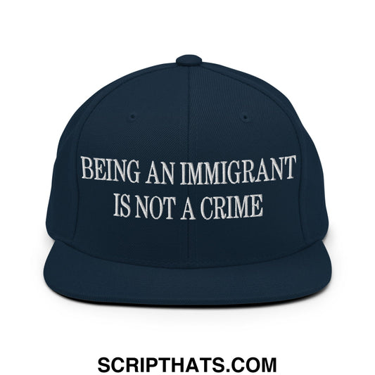 Navy blue snapback hat with white embroidered text being an immigrant is not a crime flat bill brim design