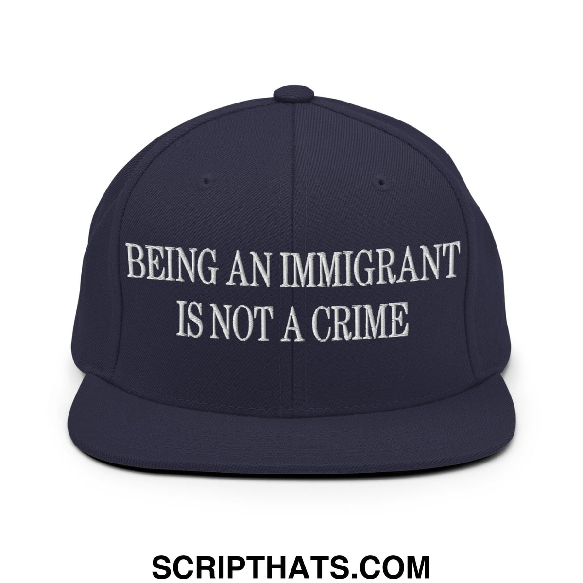 Navy blue snapback hat with white embroidered being an immigrant is not a crime text and flat bill brim design