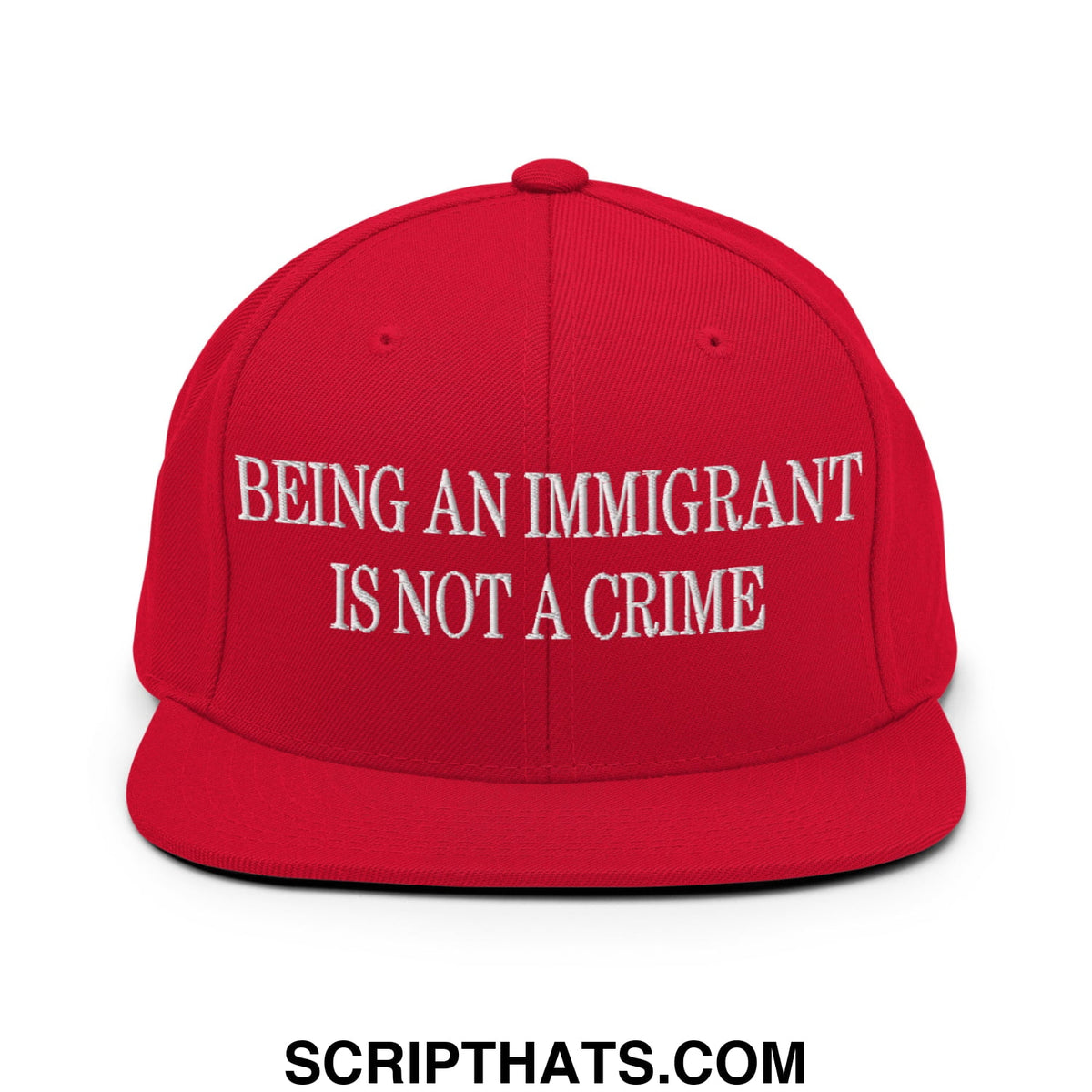 Red snapback hat with white embroidered being an immigrant is not a crime text and flat bill brim design