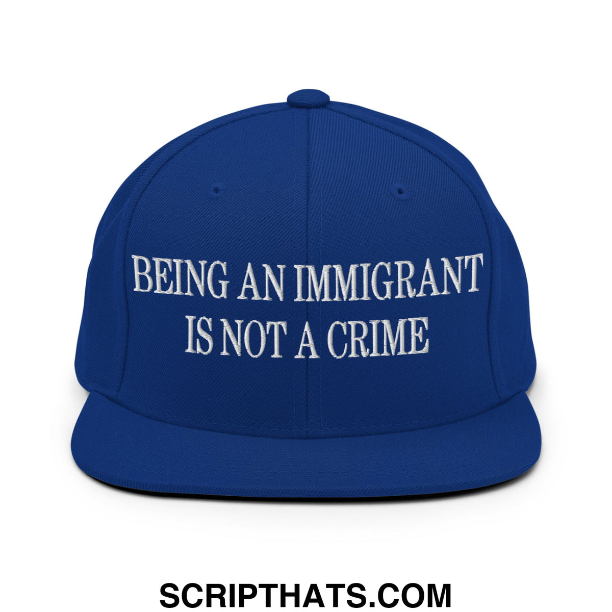 Royal blue snapback hat with white embroidered text being an immigrant is not a crime flat bill brim design