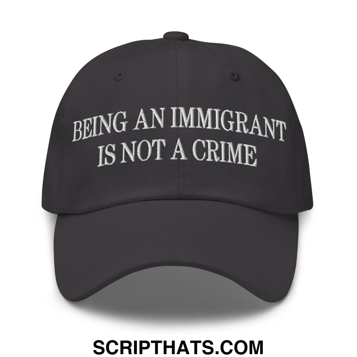 Black unstructured dad hat with white embroidered text being an immigrant is not a crime on front panel