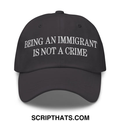 Black unstructured dad hat with white embroidered text being an immigrant is not a crime on front panel