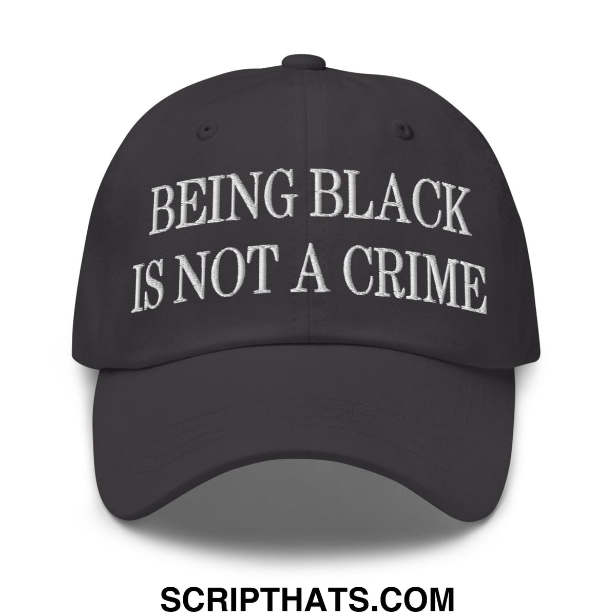 Black unstructured dad hat with white embroidered being black is not a crime text on the front panel