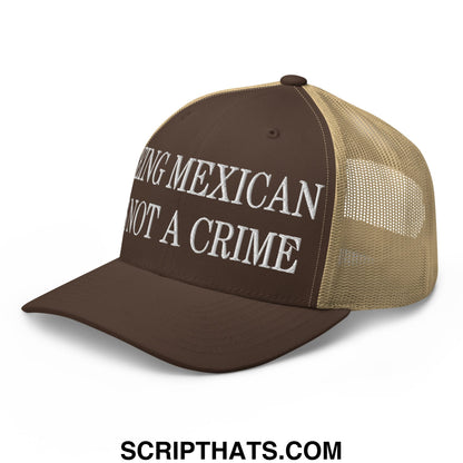Brown and tan mesh trucker hat with white embroidered being mexican not a crime text in front panel