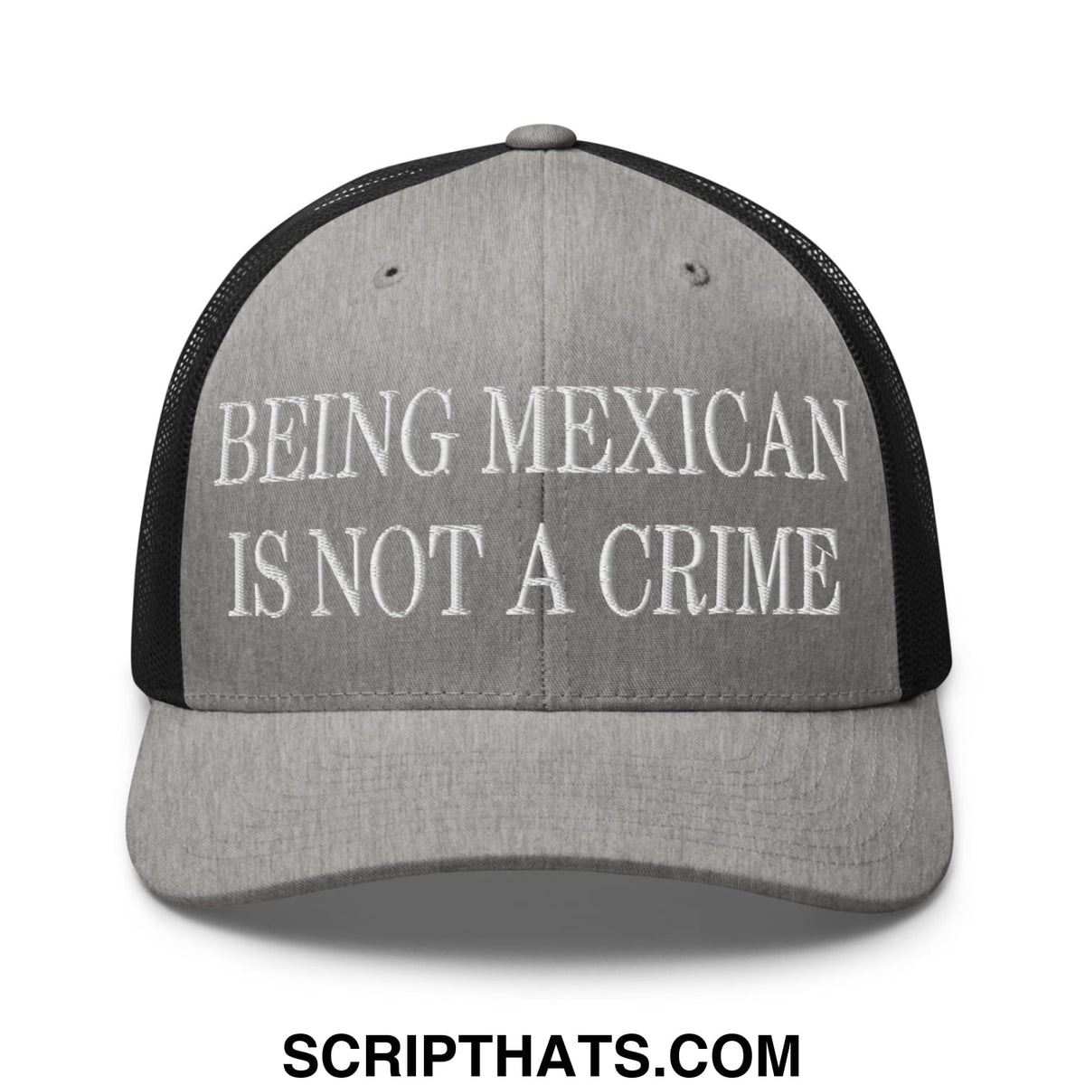 Gray and black mesh trucker hat with white embroidered text being mexican is not a crime