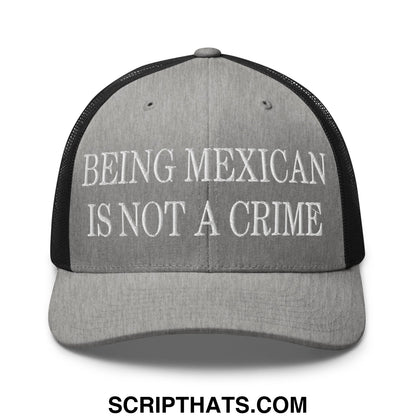 Gray and black mesh trucker hat with white embroidered text being mexican is not a crime