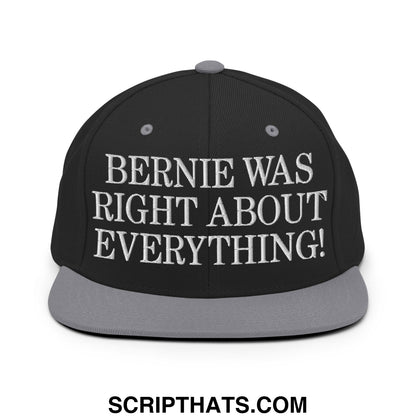 Black snapback cap with gray brim embroidered with white text saying bernie was right about everything flat bill design