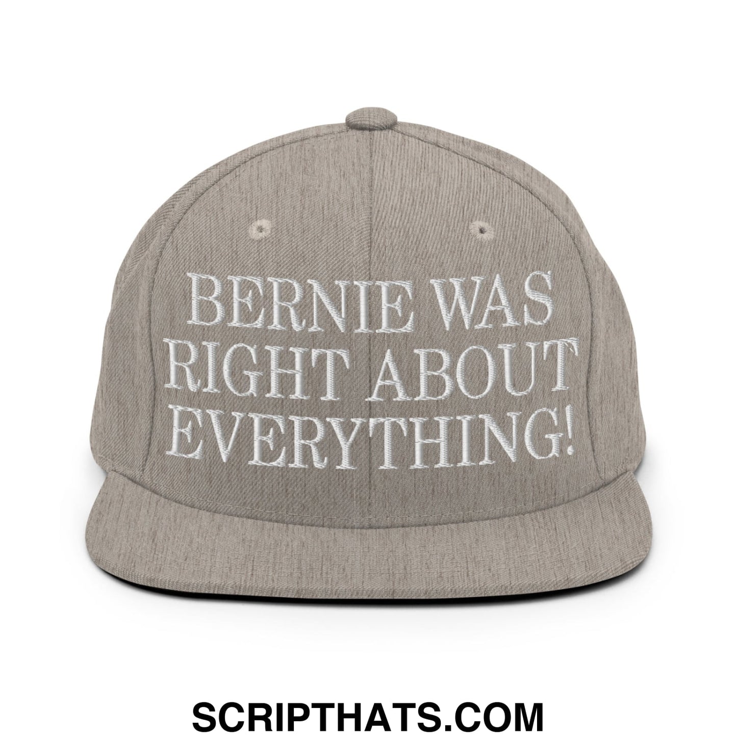 A gray snapback hat with white embroidered text bernie was right about everything featuring a flat bill brim