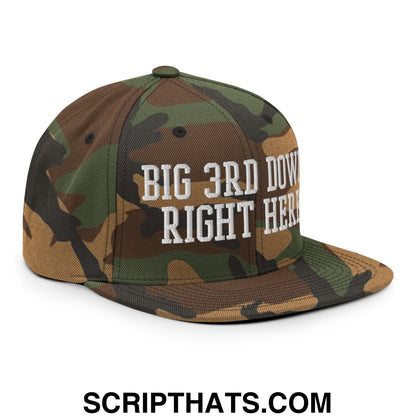 A camouflage snapback hat with a flat bill and white embroidered text big 3rd down right here on the front