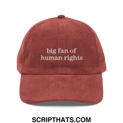 A rust-colored corduroy dad hat with white embroidered text big fan of human rights unstructured design
