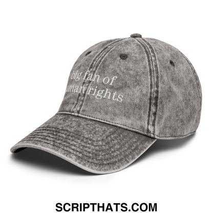 A faded gray denim unstructured dad hat embroidered with white text big fan of human rights