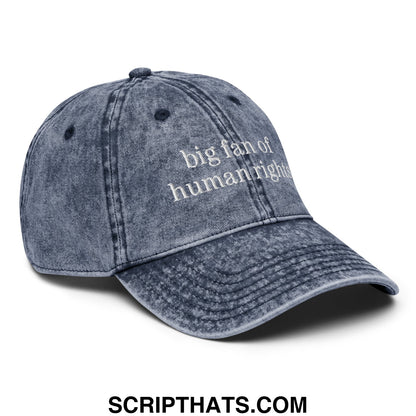 A faded blue denim unstructured dad hat with white embroidered text big fan of human rights