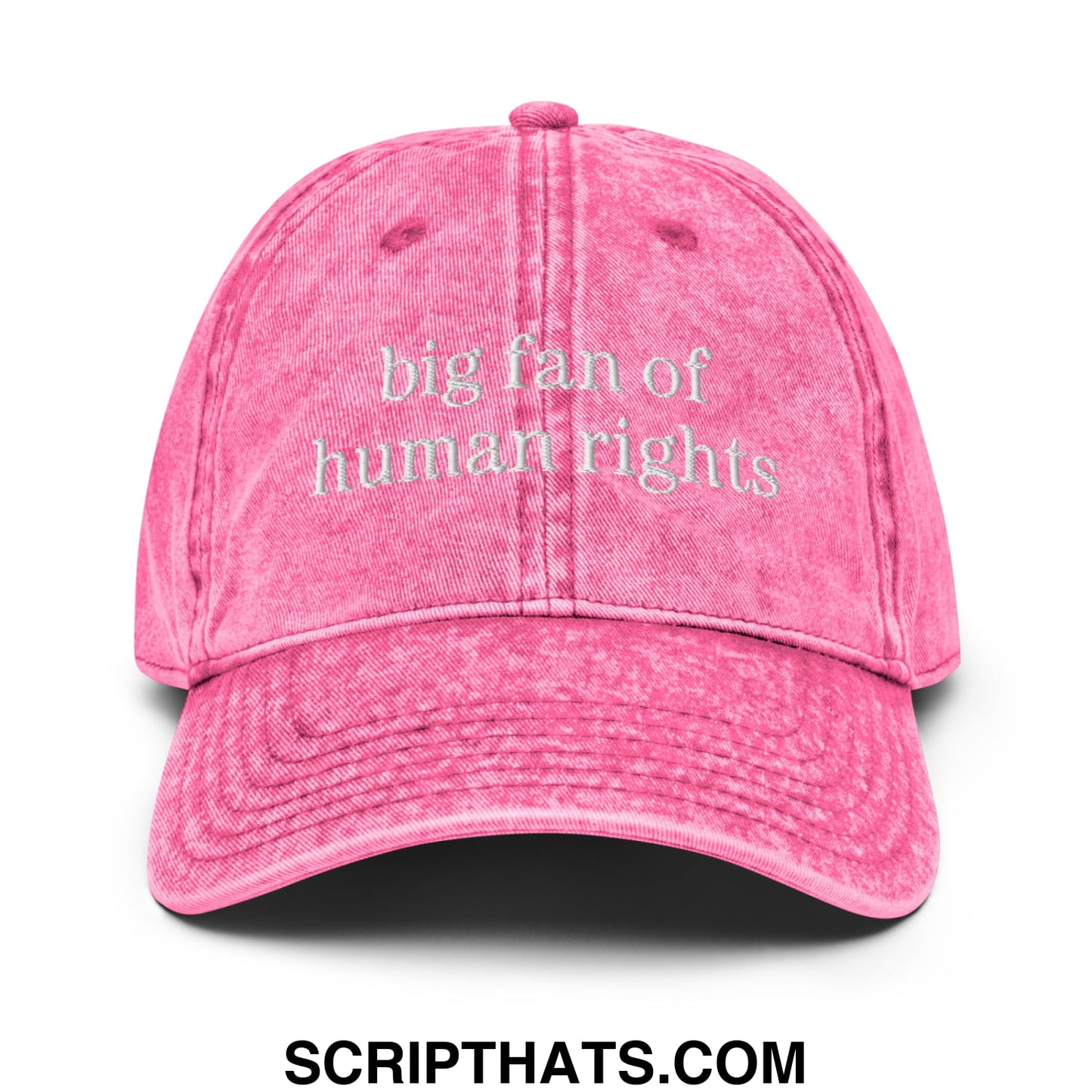 A faded pink denim dad hat embroidered with big fan of human rights text in white on the front