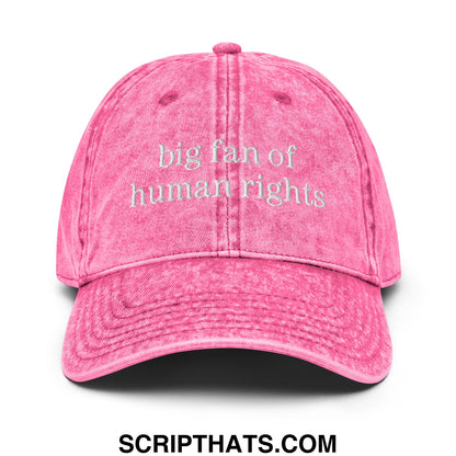 A faded pink denim dad hat embroidered with big fan of human rights text in white on the front