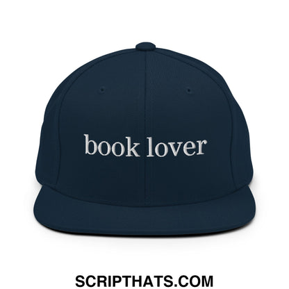 Navy blue snapback hat with white embroidered book lover text and flat bill brim perfect for casual wear