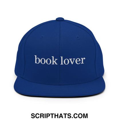 Royal blue snapback hat with white embroidered book lover text and flat bill brim for casual wear