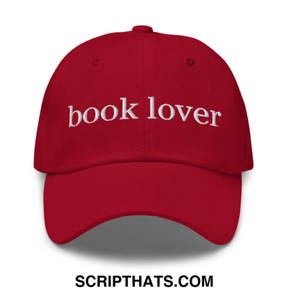 Red unstructured dad hat featuring white embroidered book lover text for casual reading enthusiasts