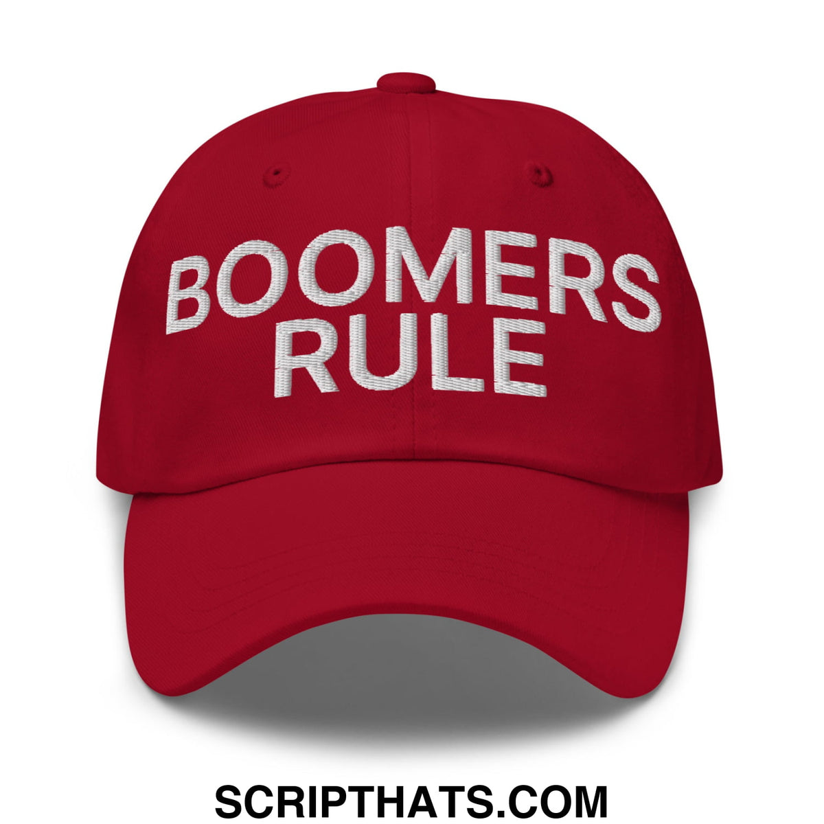 Red embroidered unstructured dad hat with boomers rule text in white thread on front panel