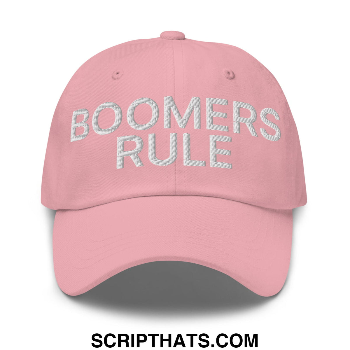 A soft pink unstructured dad hat with boomers rule embroidered in silver thread on the front