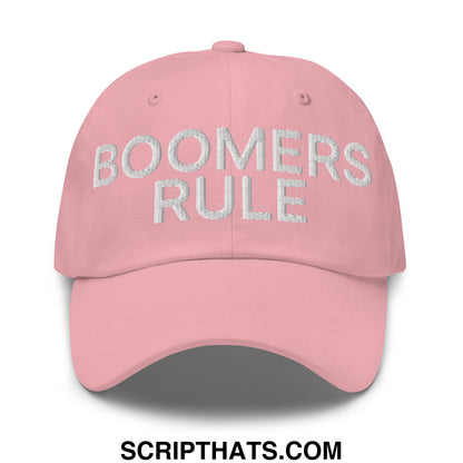 A soft pink unstructured dad hat with boomers rule embroidered in silver thread on the front